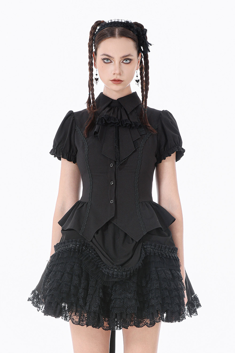 Woman wearing a black gothic-style skirt with ruffled details on a white background