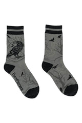 grey and black socks with crow on branch