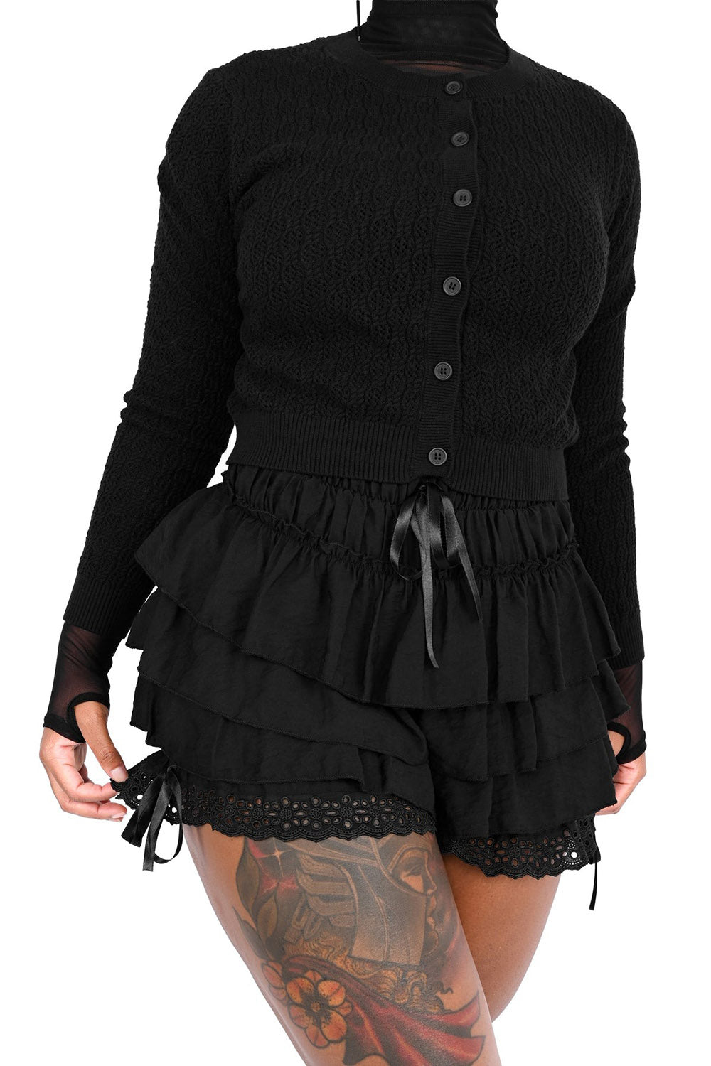 Black ruffled bloomer shorts with a cardigan on a white background