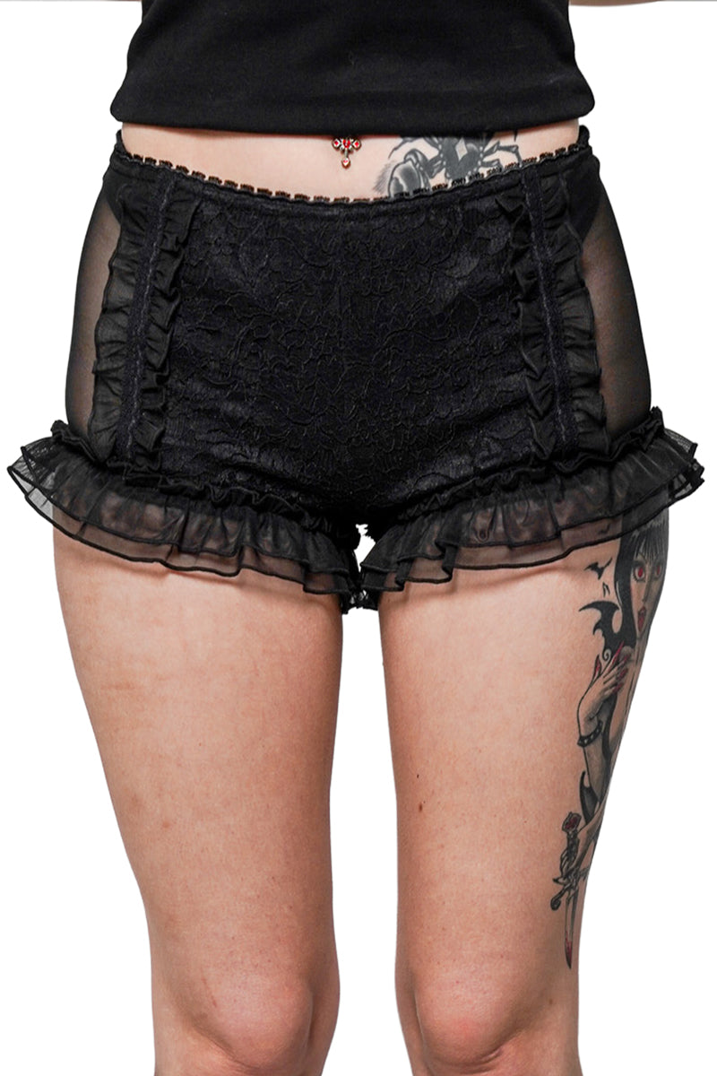 Black lace shorts worn by a person on a white background