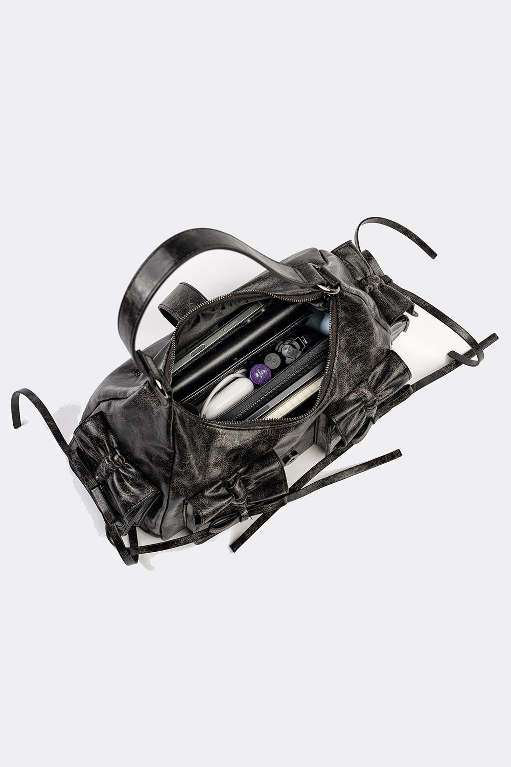 distressed shoulder bag with pockets and bows