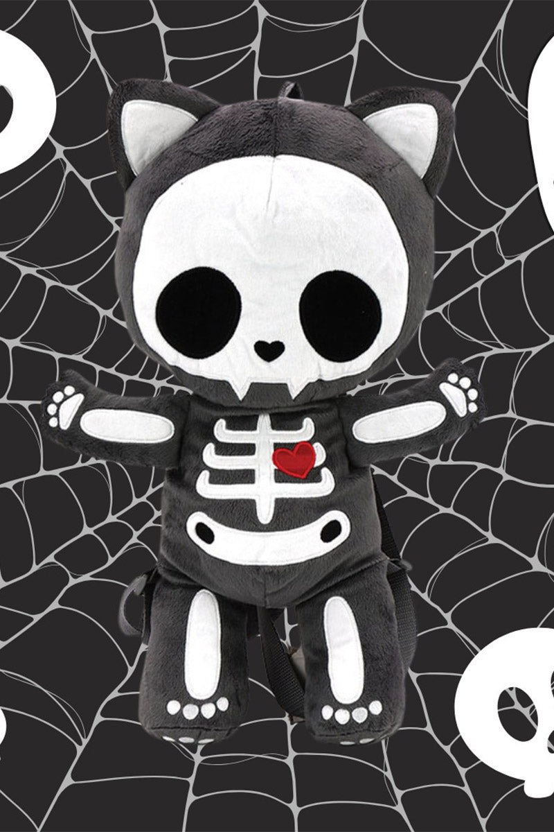 kawaii Black and white skeleton plushie backpack with a red heart on a white background