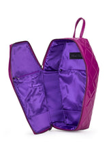 A purple quilted cosmetic bag shown open, displaying its satin purple interior pockets and a black brand label that reads 'Paul Mitchell'.