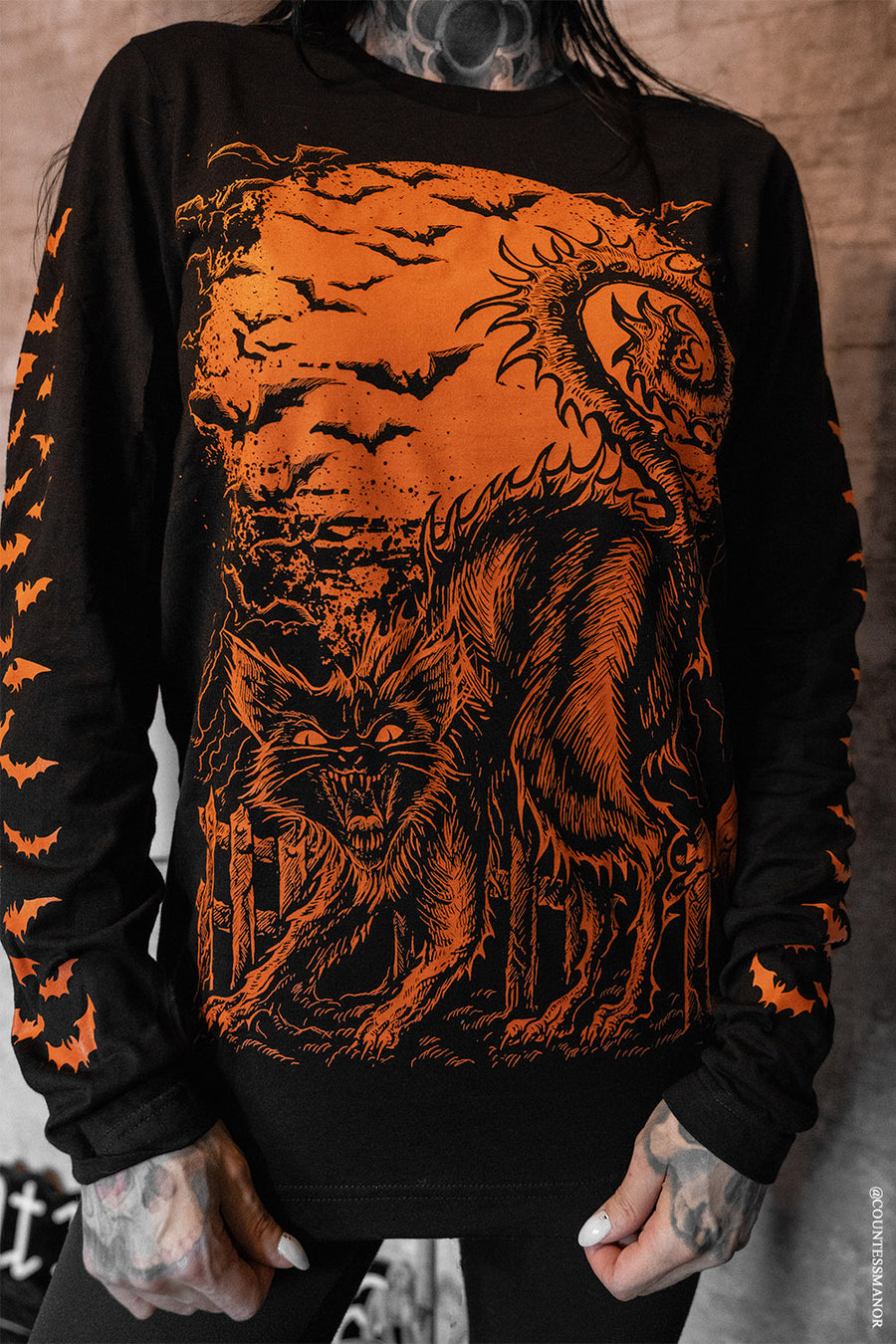orange and black halloween cat long sleeve shirt with bats on them 