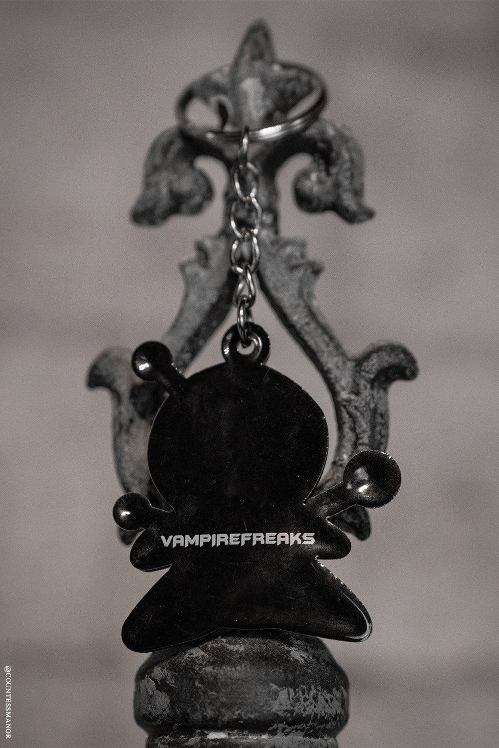 emo keychain with vampire freaks branding on the back 