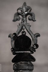 emo keychain with vampire freaks branding on the back 