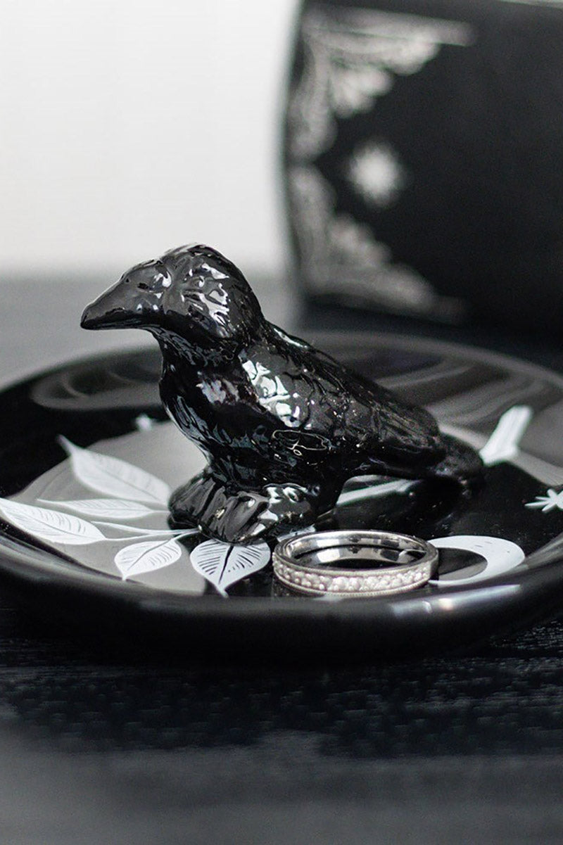 Black ceramic crow on a decorative trinket dish plate with a ring