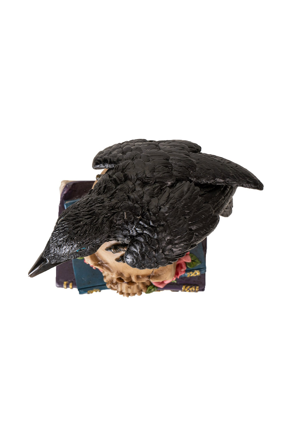 spooky raven sitting on skull statue