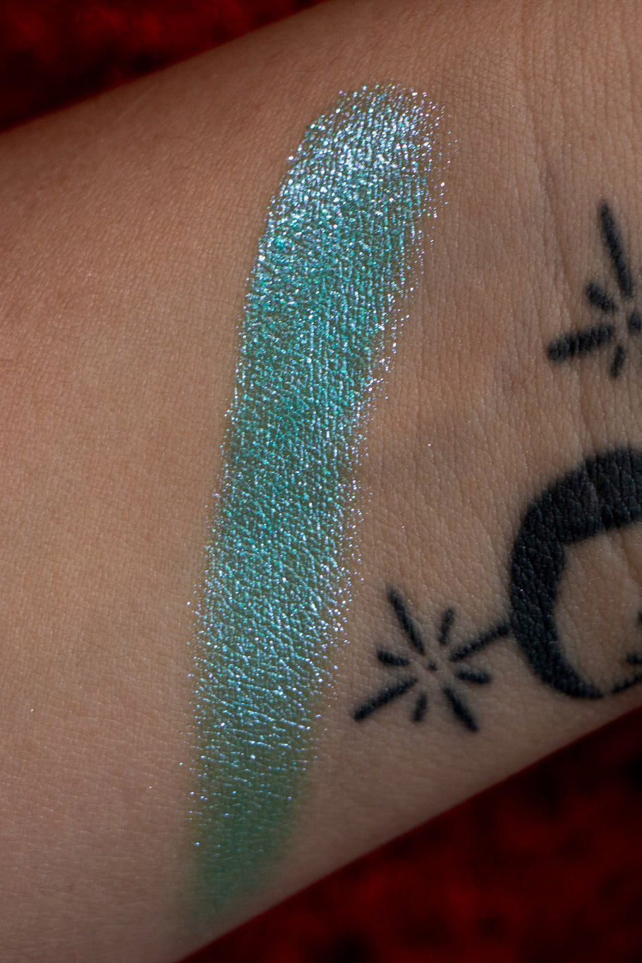 color swatch of glittery eyeshadow by curst kosmetics