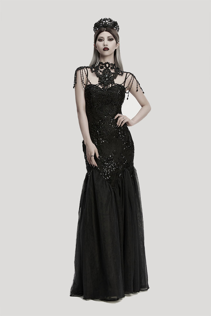 Woman wearing a black evening gown with intricate detailed gothic necklace on a white background
