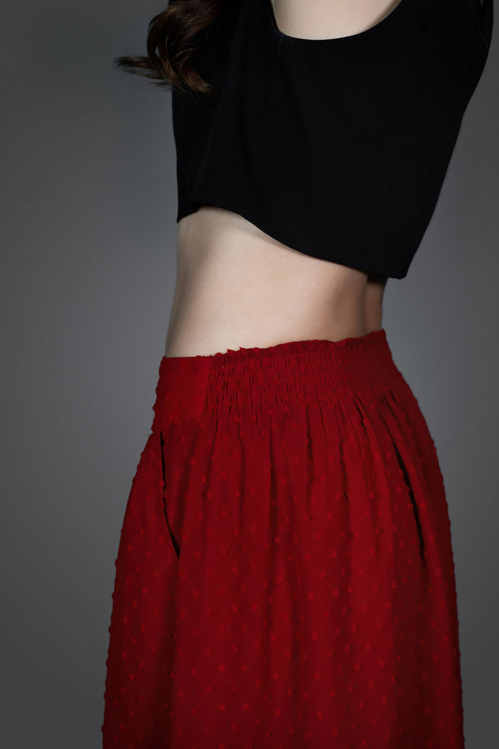 womens flowing red high-waisted skirt with v-shaped hem and pockets