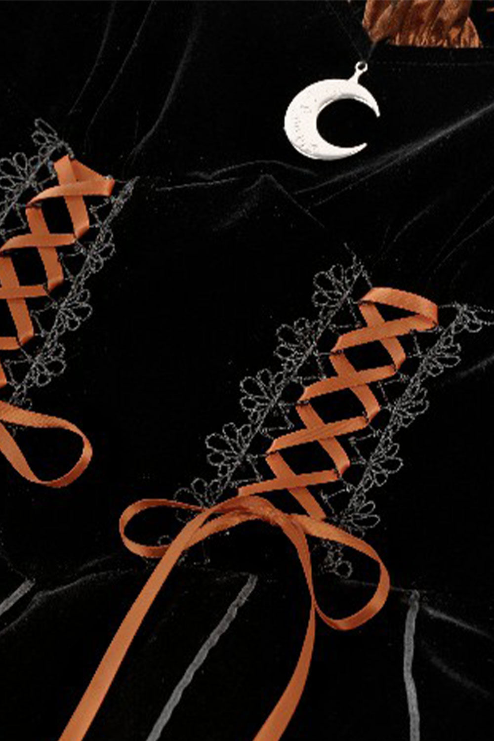 Witchy bat dress in orange and black with moon pendant fabric detail