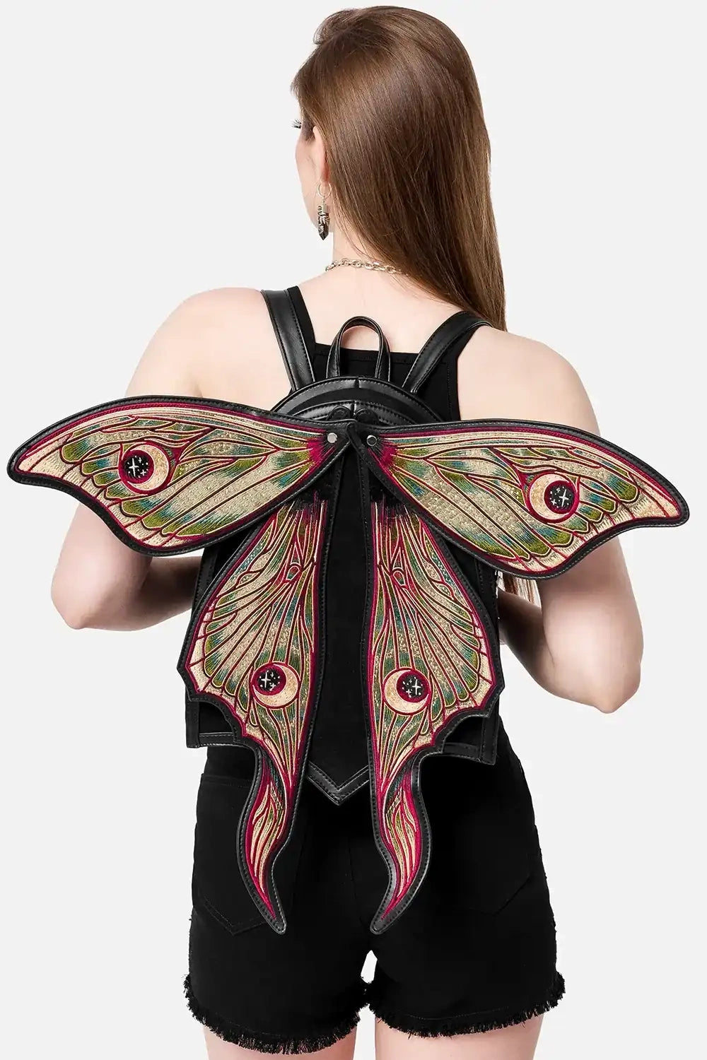 Person wearing a backpack with moth wings design on a white background