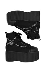 Black platform boots with embroidered chain details on a white background