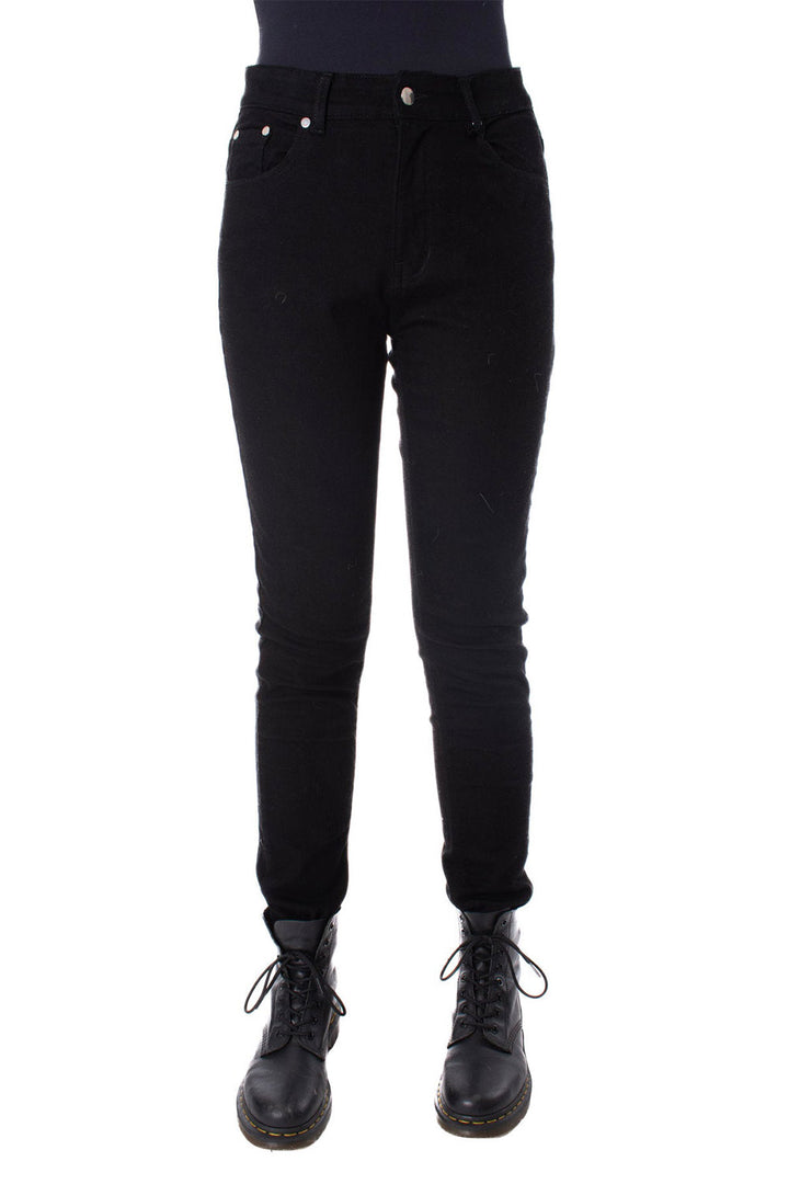 Black pants worn by a person on a white background