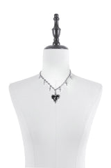 spiked black heart punk necklace on a cross chain