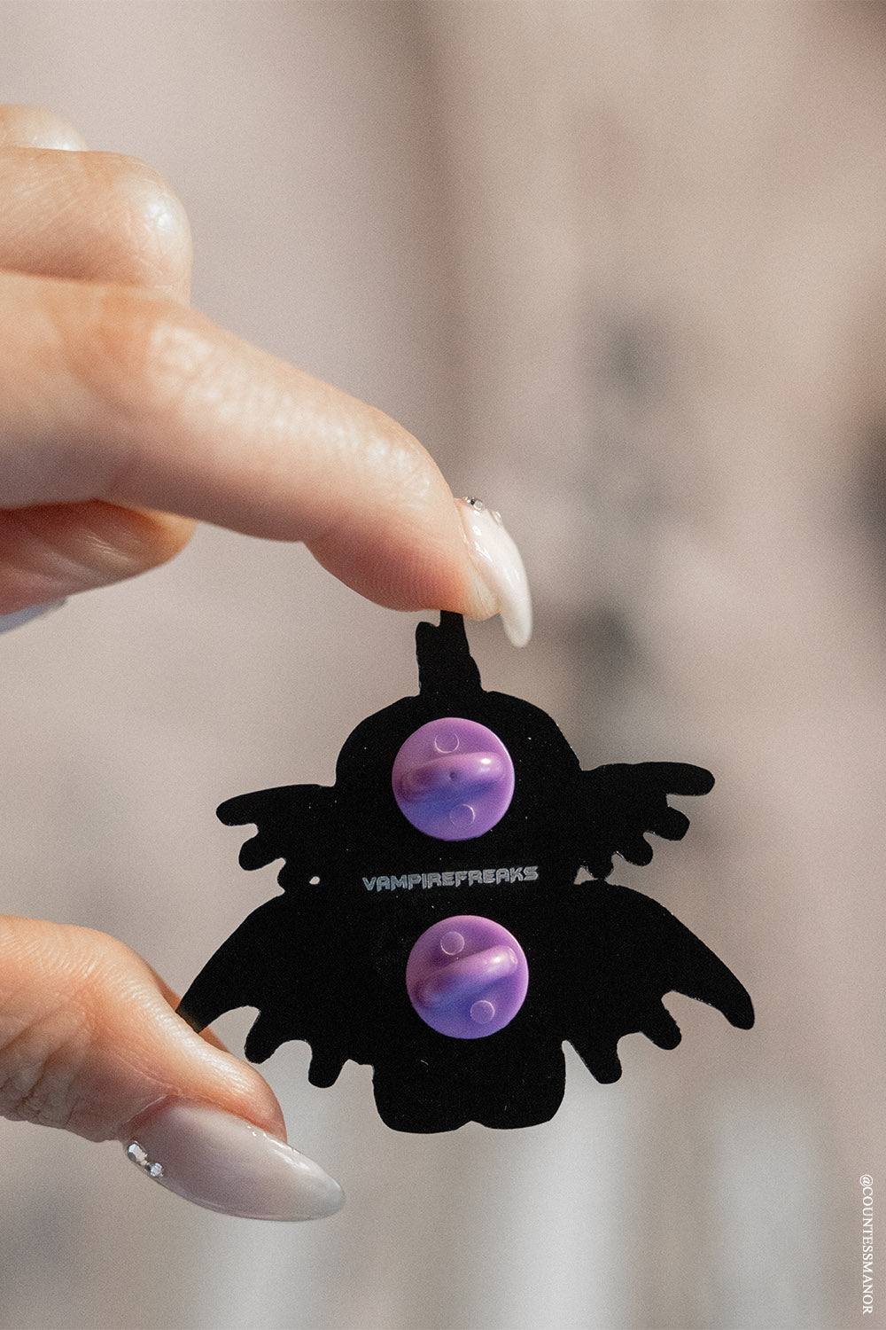 sea monster enamel pin with purple back button close