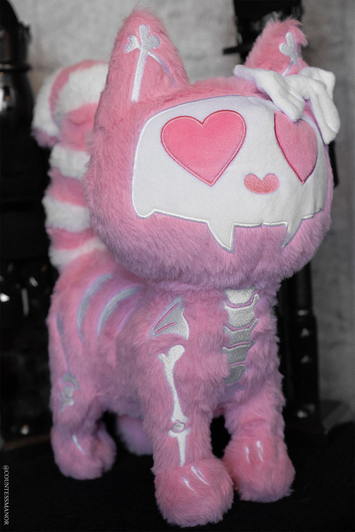 pink and white creepy cute kawaii skeleton cat stuffed animal  with a hair bow