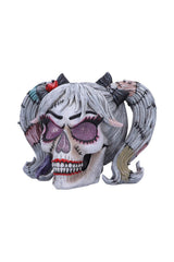 skull figurine with pigtails 