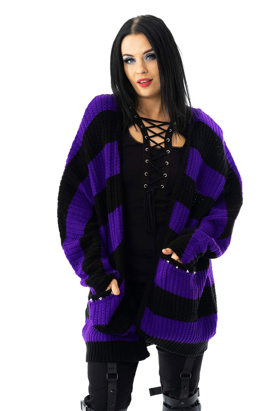 Woman wearing a black and purple striped cardigan on a white background
