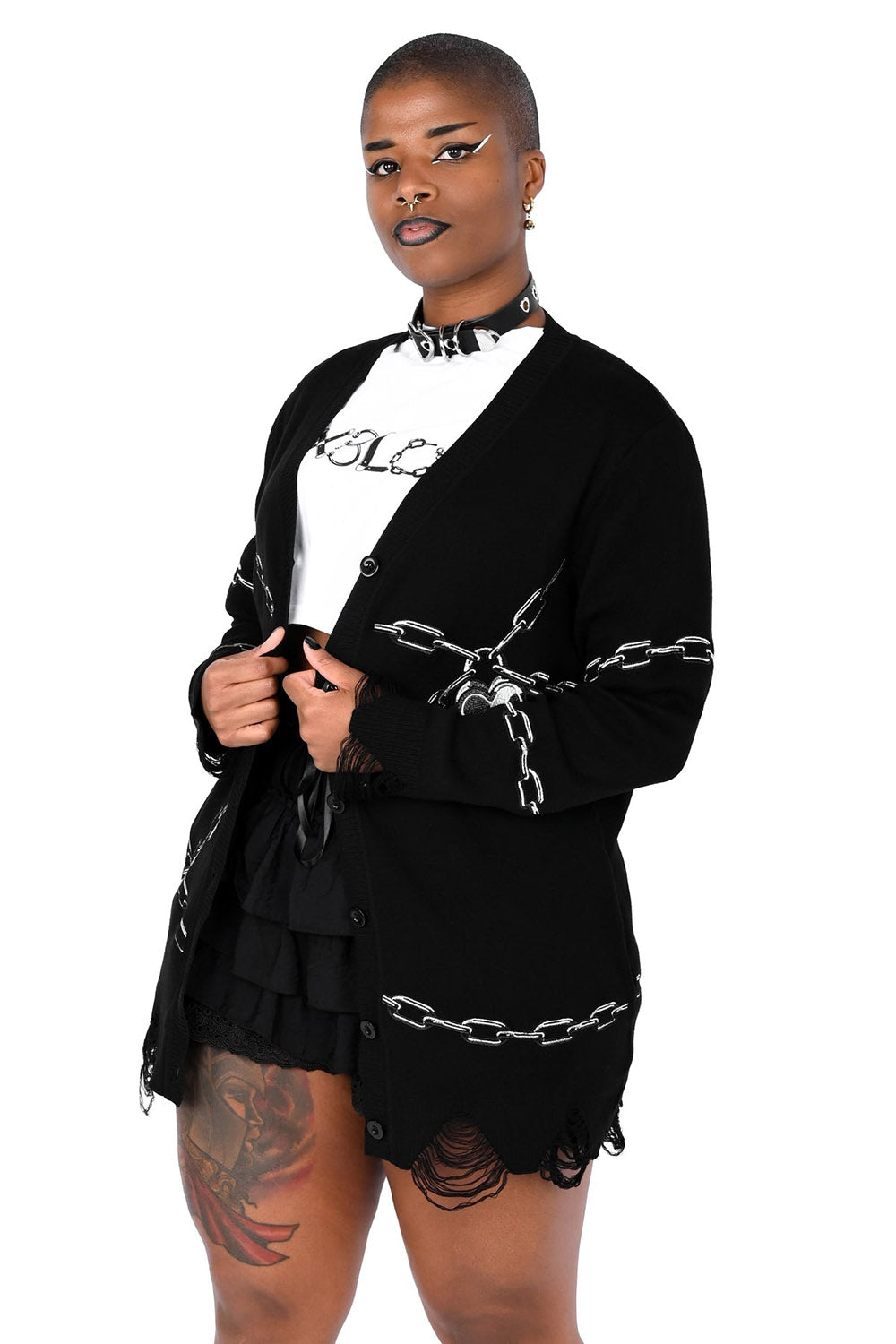 Person wearing a black outfit with chain designs on a white background