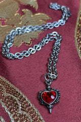 long chain necklace with dagger piercing heart pendant