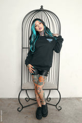 gothic woman wearing a black gothic fairy sweater with moth wings on the back