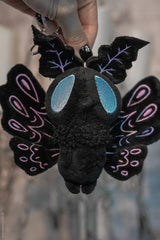 small black, light blue, and pastel purple luna moth plush toy keychain