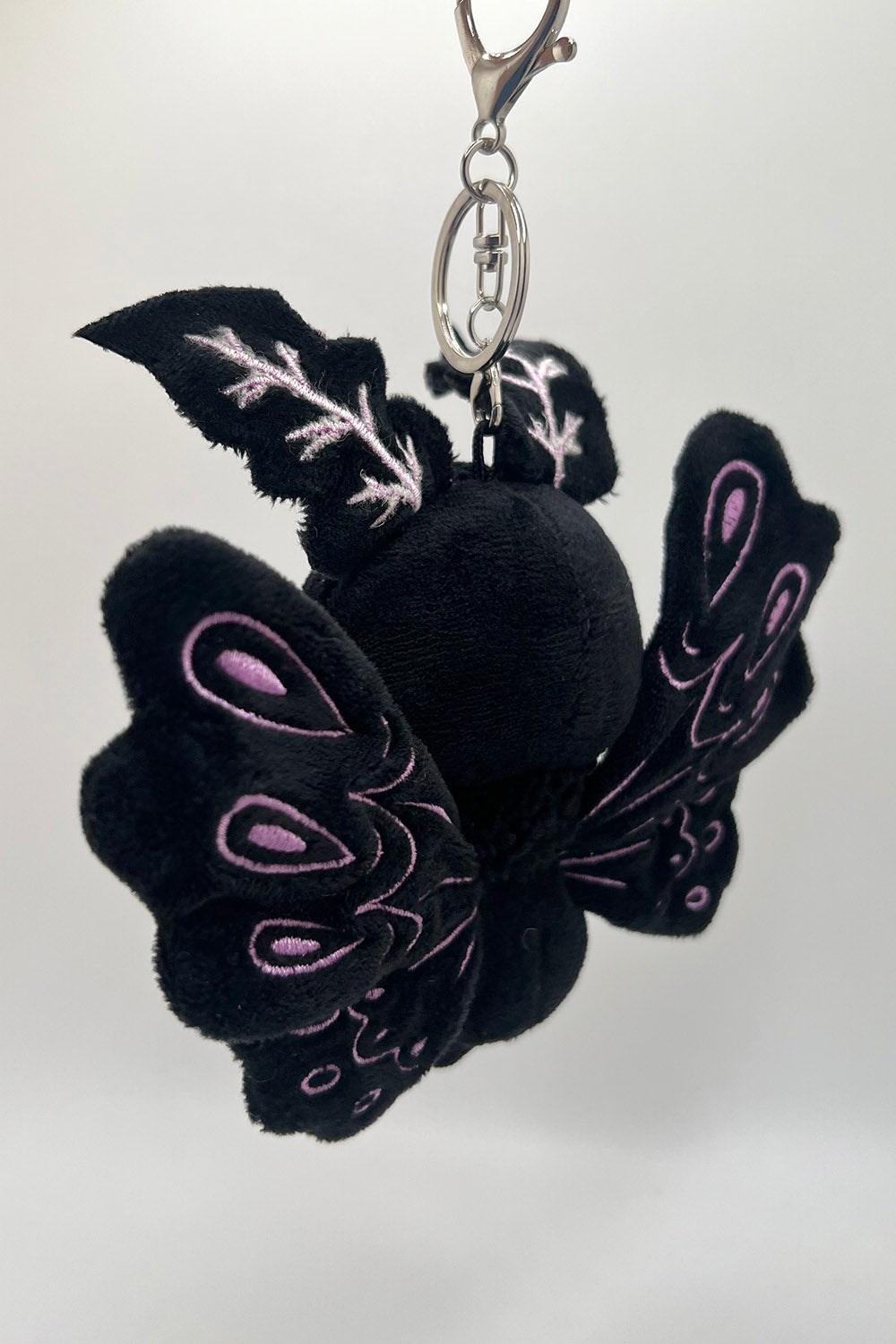 black, blue, and purple pastel goth plush keyring 