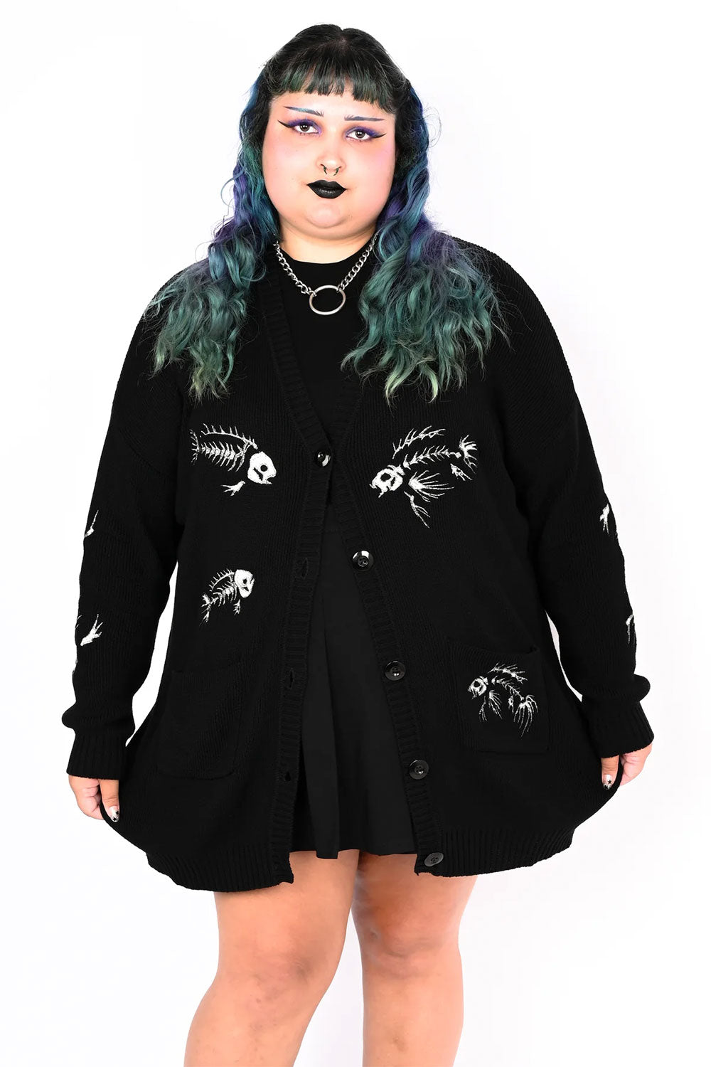 Black button up cardigan with an embroidered fish skeleton pattern