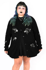 Black button up cardigan with an embroidered fish skeleton pattern