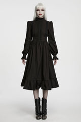 model wearing midi length black dress with ruffle sleeves from punk rave