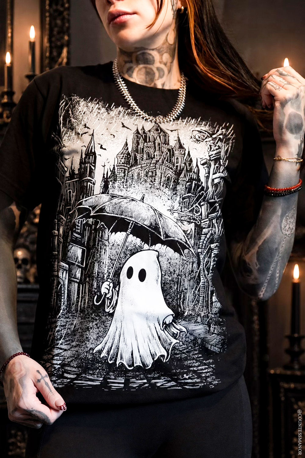 creepy cute graphic tshirt with ghost holding umbrella on a rainy day