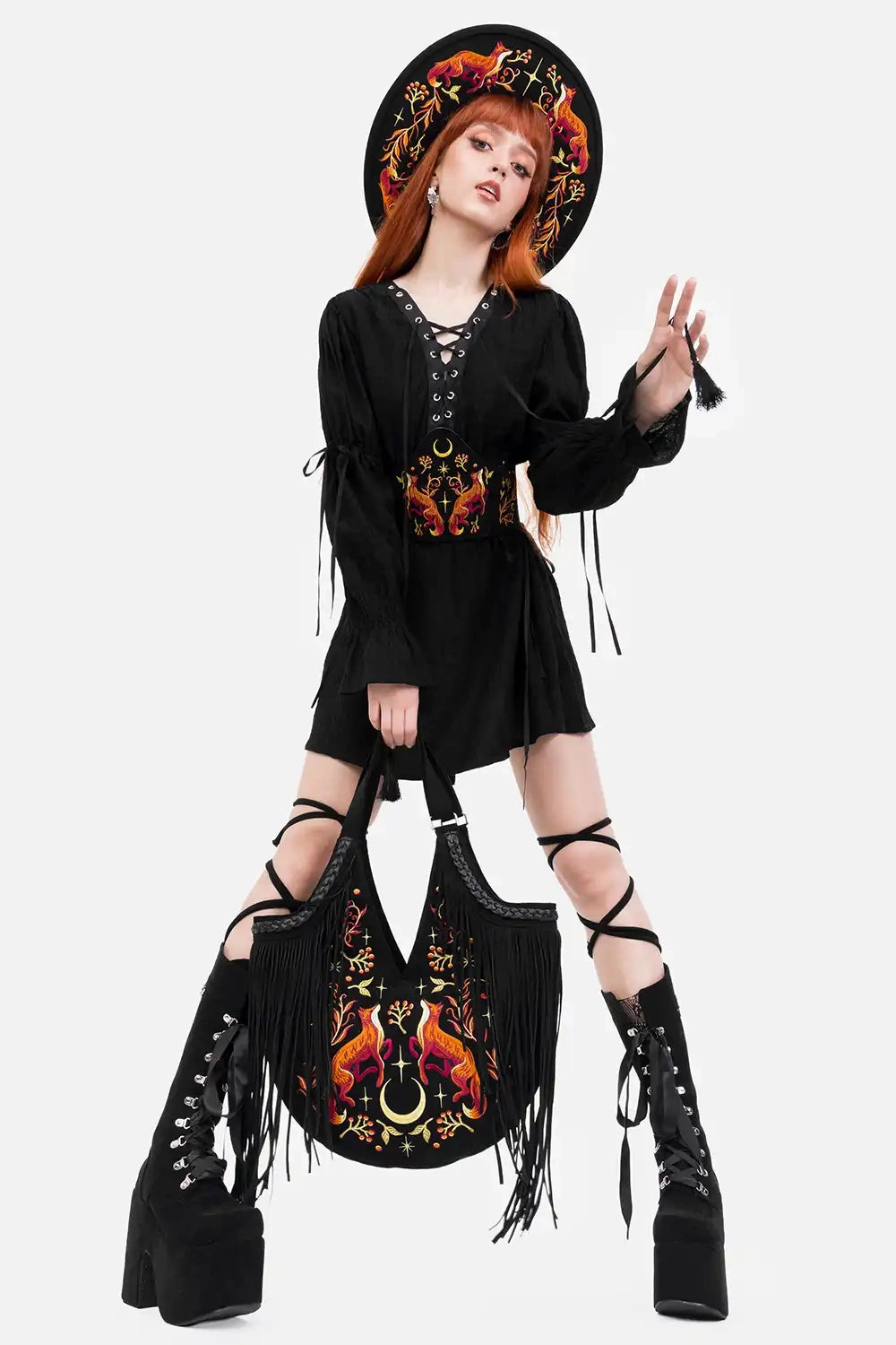 gothic woman wearing a embroidered animal fox bag