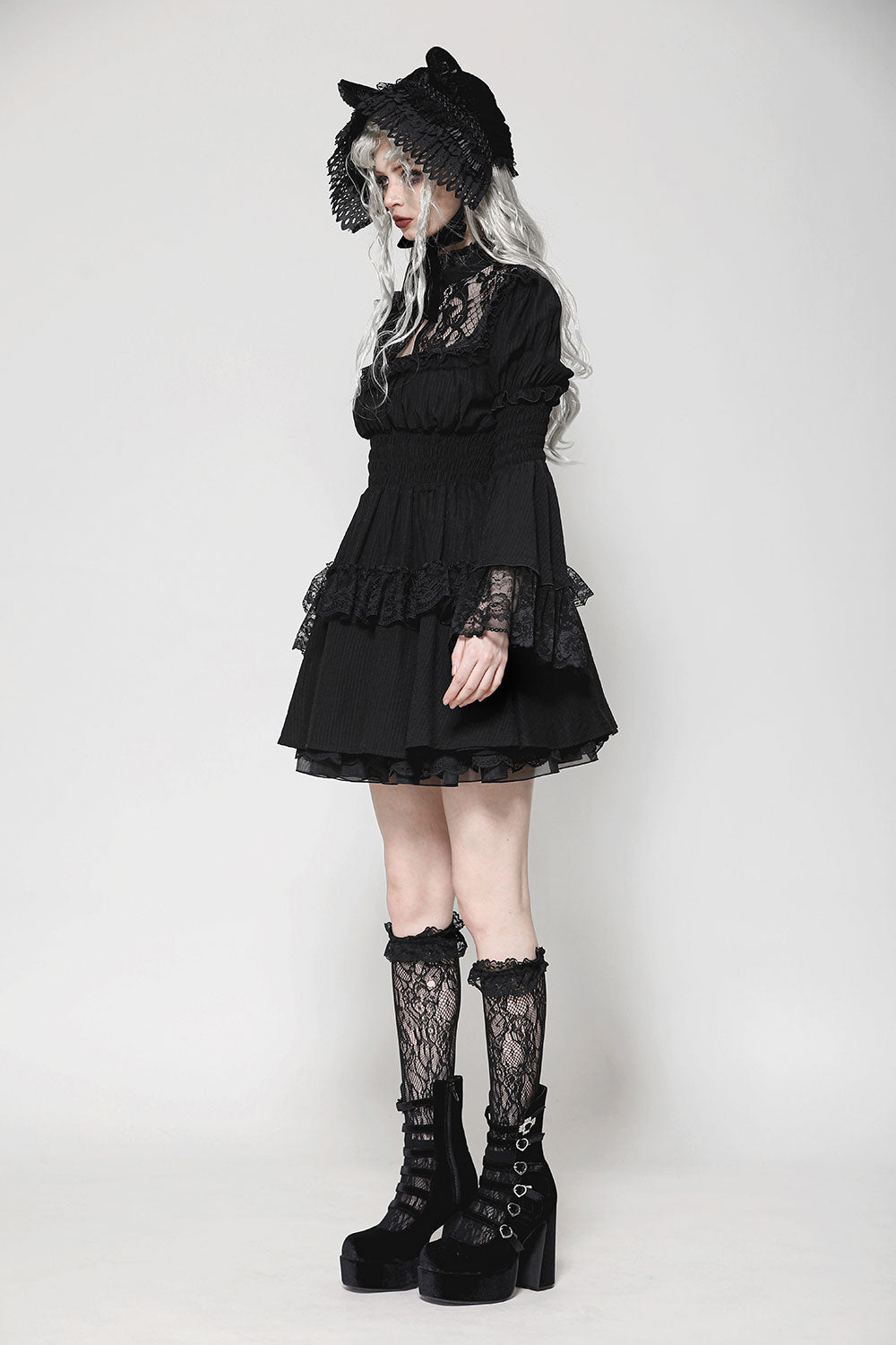 Side view of model wearing dark in love gothic lace doll dress