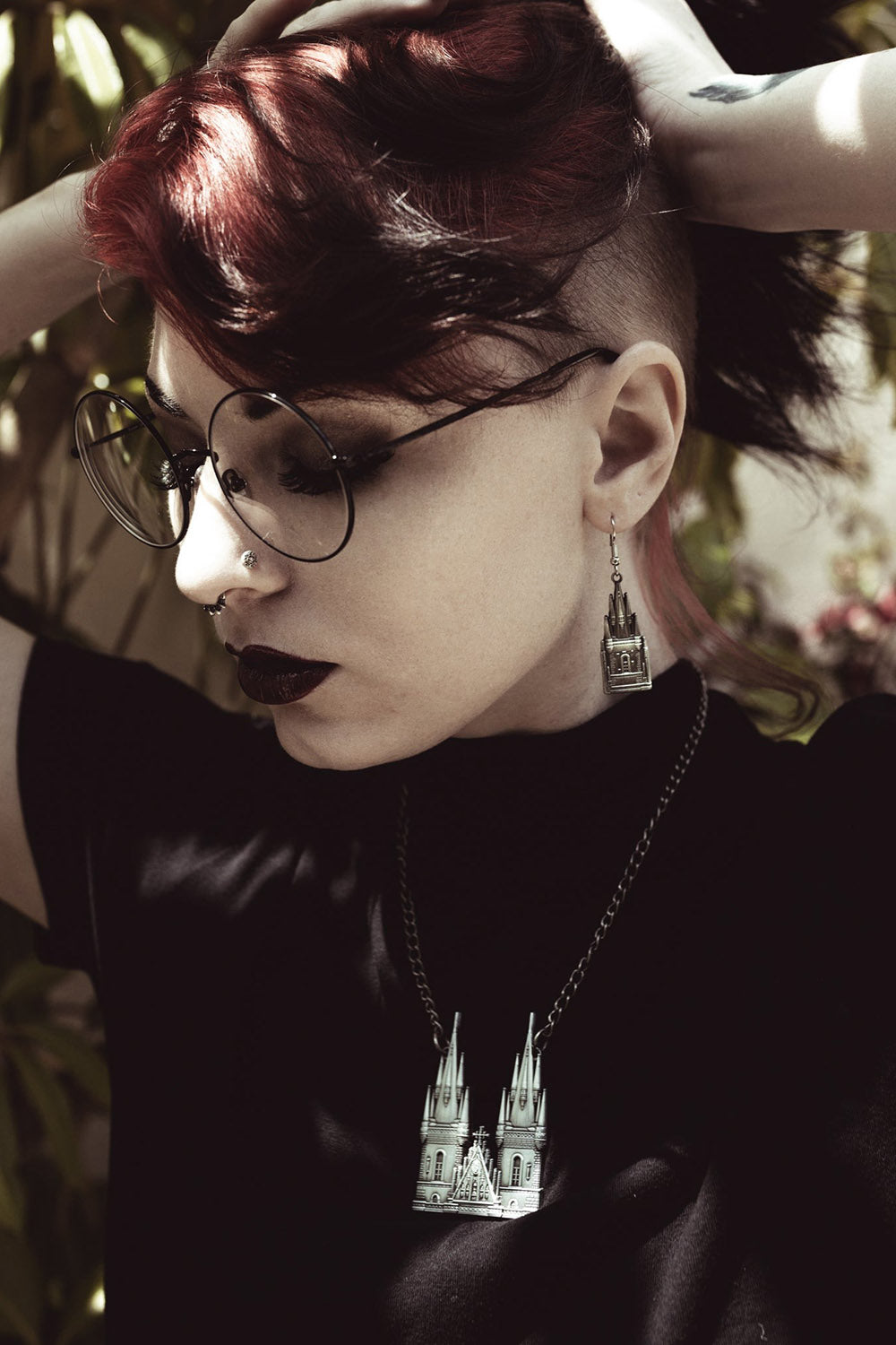 woman wearing gothic cathedral earrings