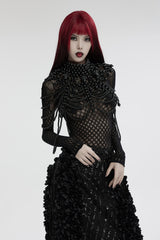 Person wearing a black, intricate dress with red hair on a white background