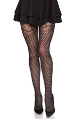 Black fishnet tights worn with a black skirt on a white background