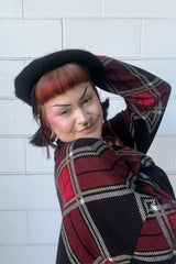 goth woman wearing a bat beret hat