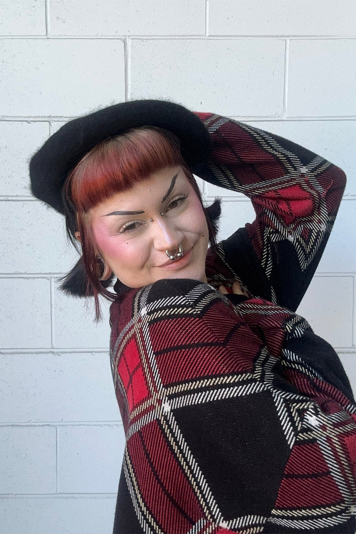 goth woman wearing a bat beret hat