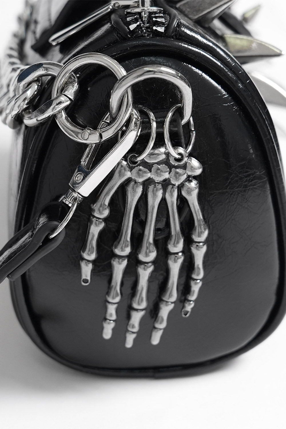 long spiked black mini chain strap bag with skeleton hand charm