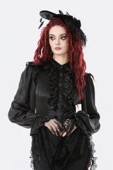 Woman wearing a black gothic outfit with ruffles and lace on a white background