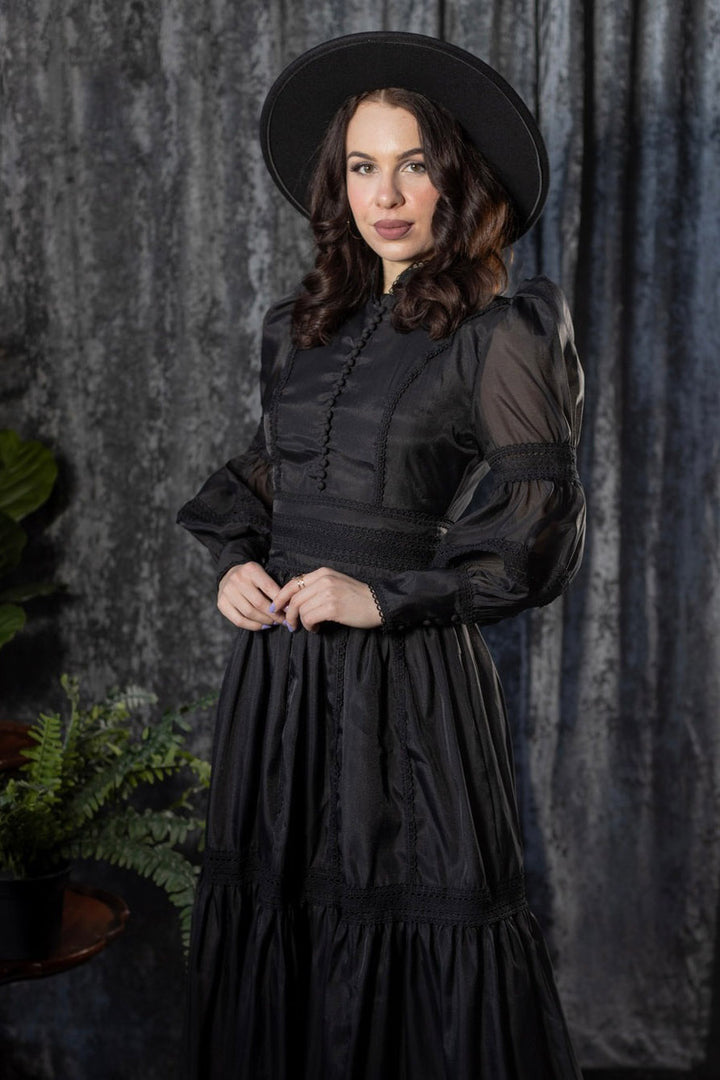 high collar buttoned woman in black gothic dress