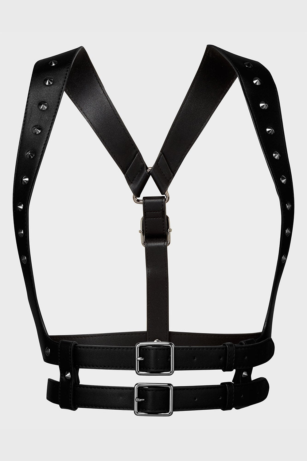 Black leather harness with studded details on a light gray background