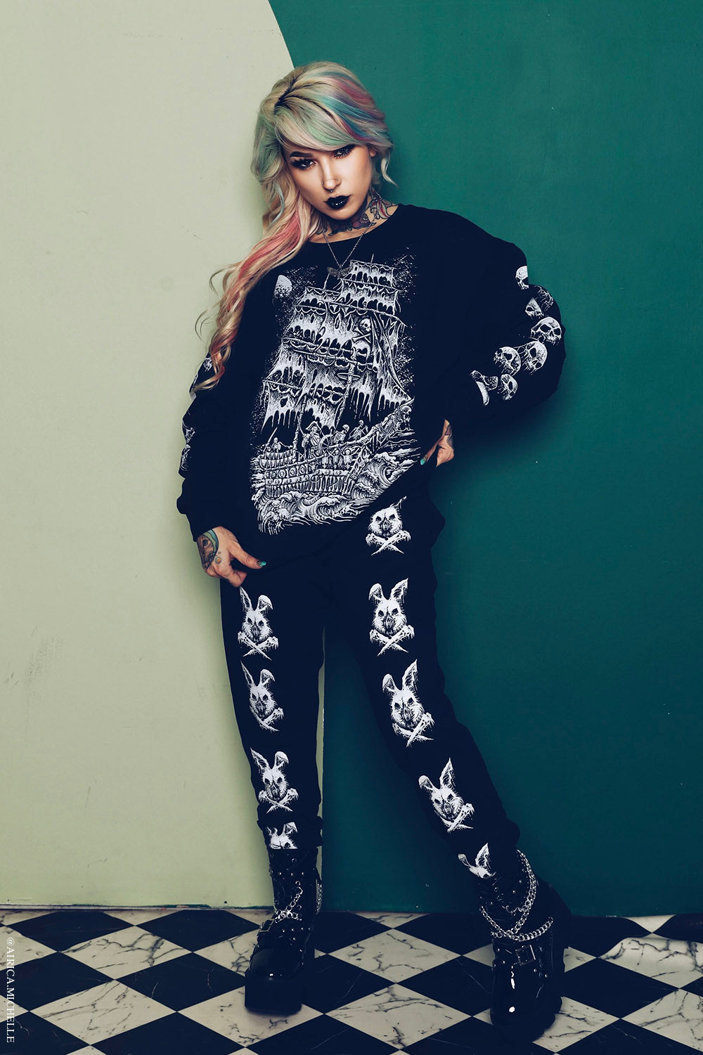 tattooed woman wearing a gothic loungewear suit 