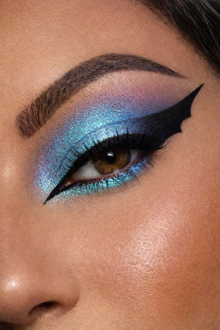 Close-up of a person's eye with blue and purple makeup