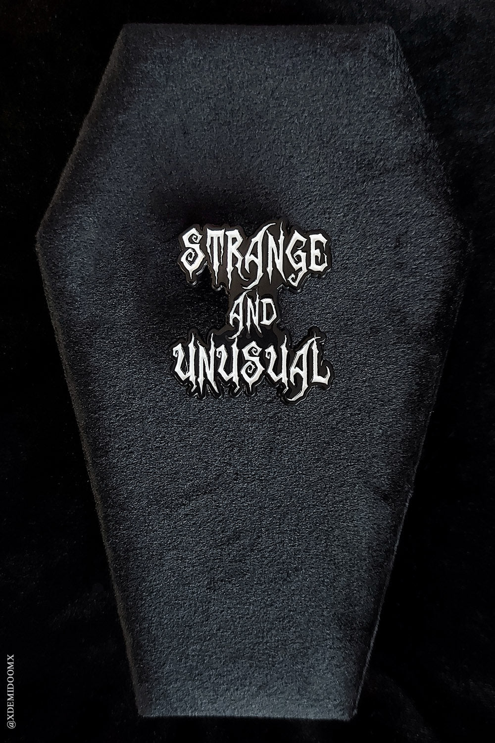 strange and unusual text enamel pin