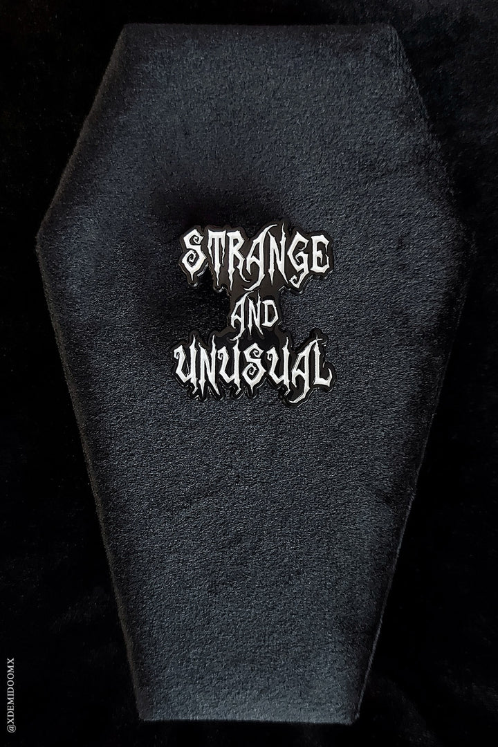 strange and unusual text enamel pin