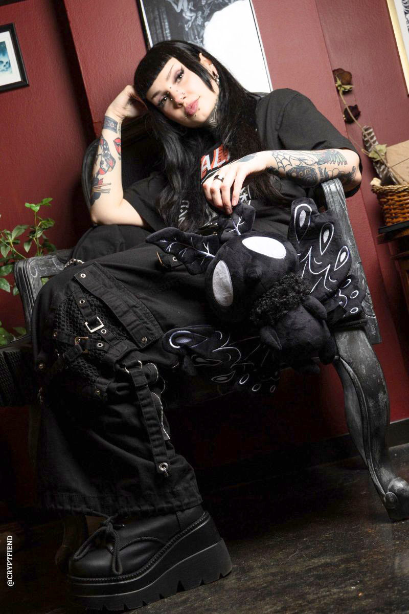 gothic woman and a moth plushie