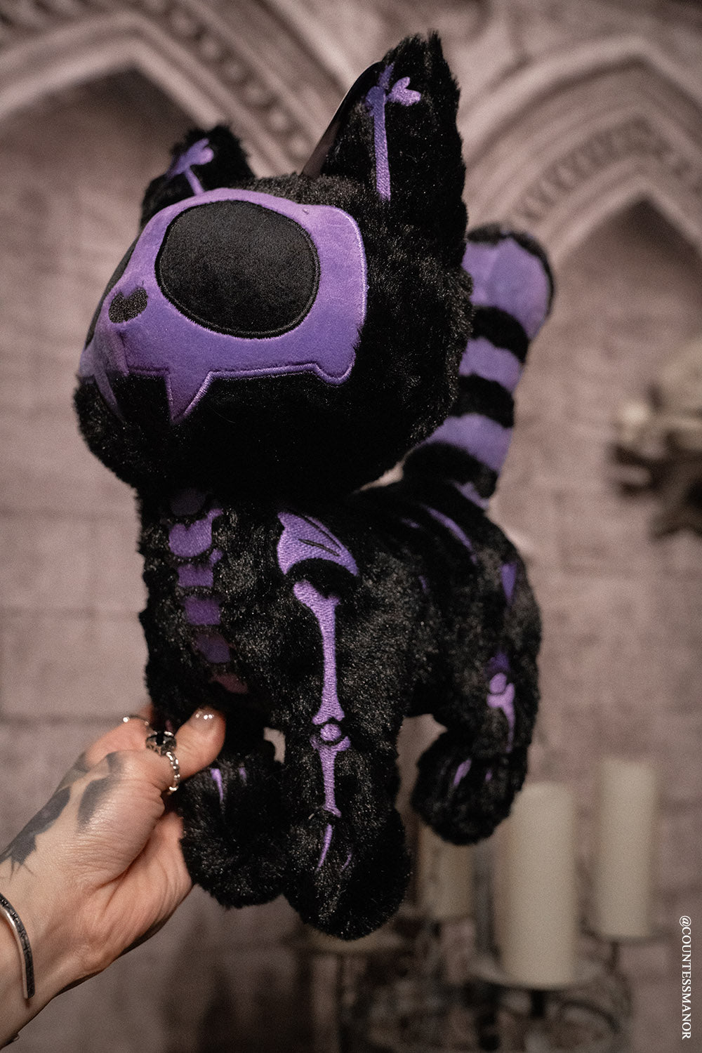 purple and black skeleton cat plushie